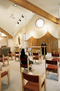 celebrating the spaciousness of the new chapel: Sr. Mary Anne at the lecturn and Sr. Mary Jo seated 